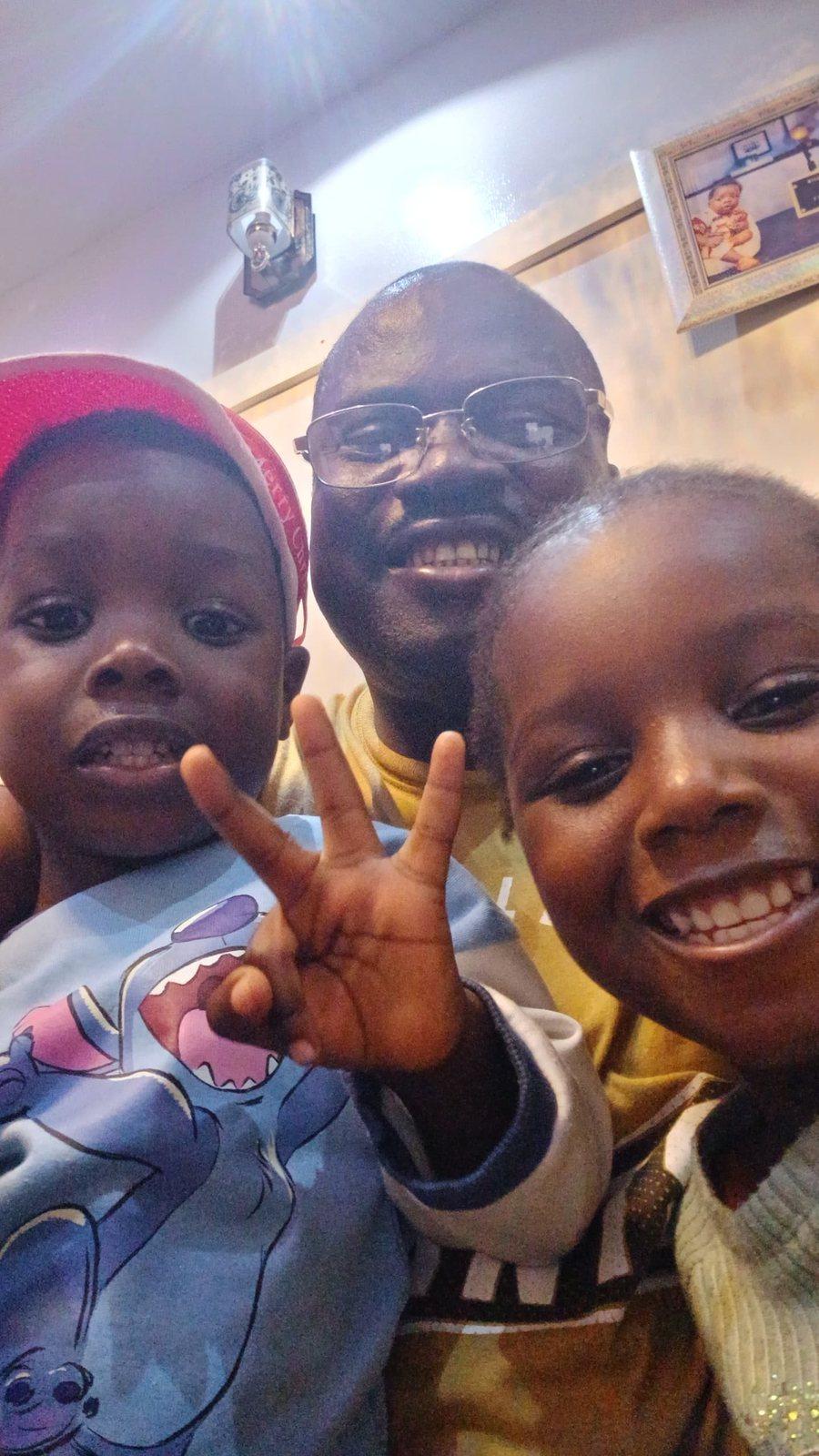 Padre Mike with two children