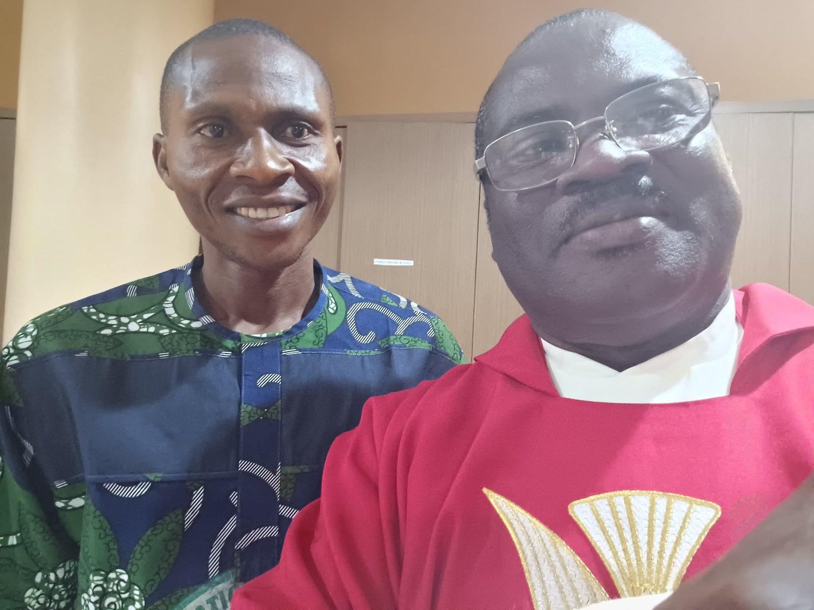 Padre Mike in red vestments with a friend