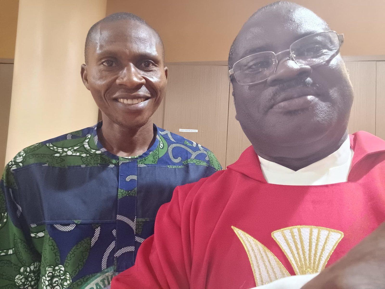 Padre Mike in red vestments with a friend