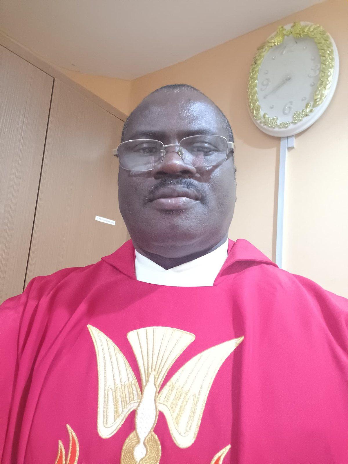 Padre Mike in red vestments